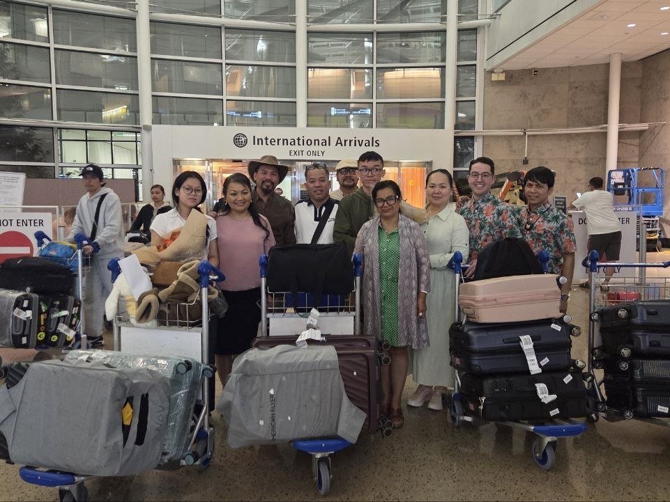 Cambodian students and parents with their luggage at International Arrivals in the USA