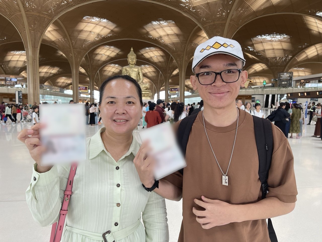 A Cambodian student and his mother with their US visas at the airport in Phnom Penh